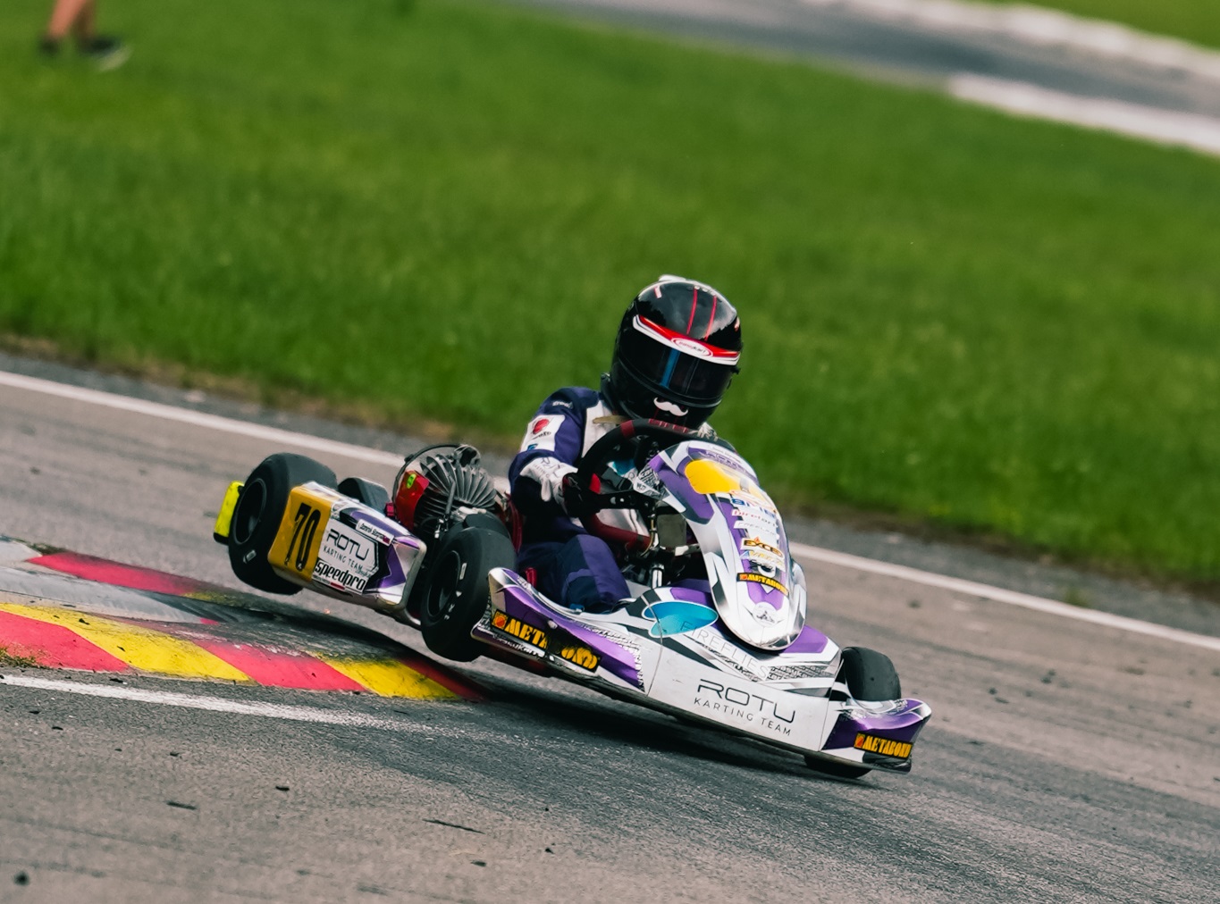 Dominik Stégmár racing his number 70 kart through a braking zone on track